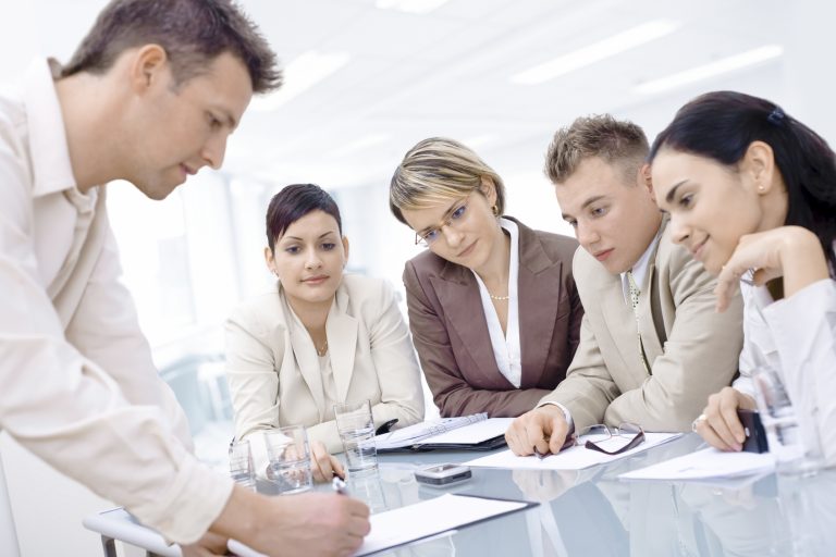 A group of people gathered around a desk